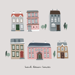 Fototapeta premium Set of hand drawn colorful old houses. Real estate icons isolated on white background. Town, village concept, urban landscape. Collection of vector cartoon illustrations.