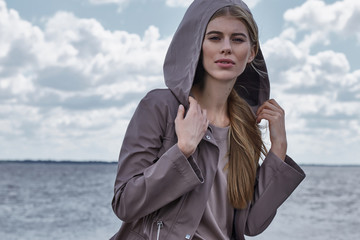 Beautiful sexy young blond woman with long hair and soft natural makeup wearing jacket designer...
