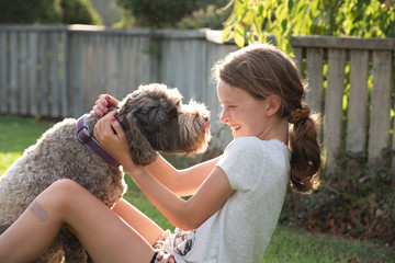 girl playing wth pet dog