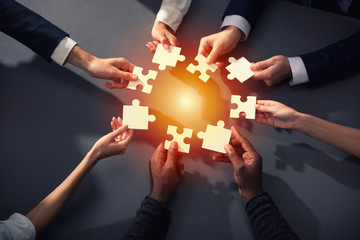 Teamwork of partners. Concept of integration and startup with puzzle pieces