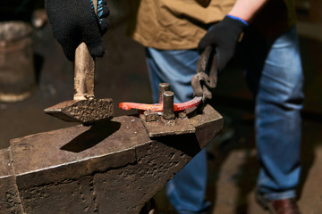 blacksmith forges a horseshoe, close-up