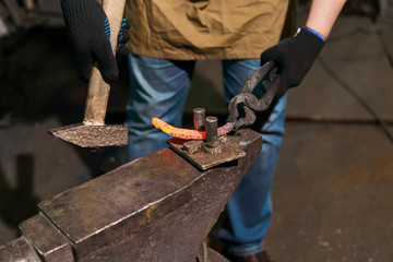 blacksmith forges a horseshoe, close-up