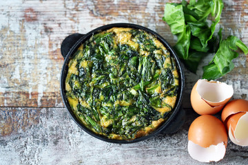 Selective focus. Keto diet ideas. Healthy omelet with spinach in a pan.
