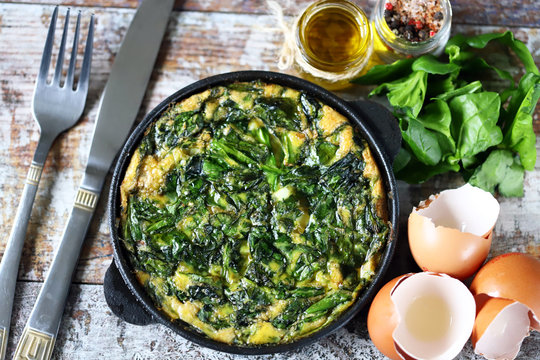 Selective focus. Keto diet ideas. Healthy omelet with spinach in a pan.
