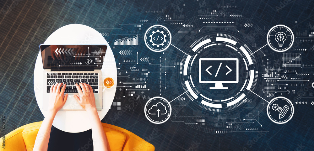 Wall mural web development concept with person using a laptop on a white table