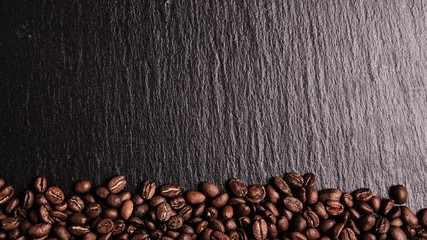Coffee beans on a slate board. Top view. Copy space..