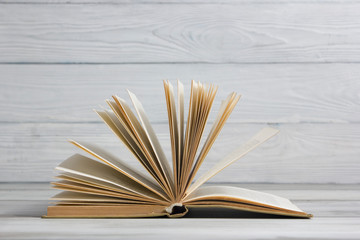 Open book, hardback books on wooden table. Back to school. Copy space