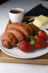 croissant with fresh strawberries and coffee 