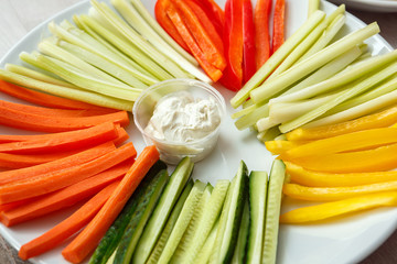 Sliced cucumbers, carrots, celery, peppers on a plate