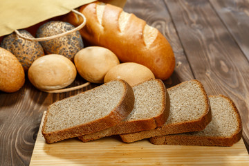 Loaf of bread and rolls in a paper bag