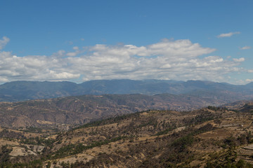 Naklejka premium Mountains and hills on the road to Quiche in Guatemala - mountains with few trees - environmental deforestation