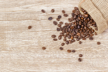 Warm coffee on a wooden plate backgrounds. Vintage backgrounds, Beans backgrounds. Copy space menu.