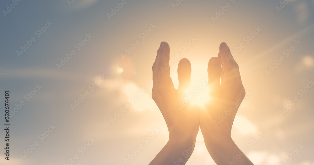 Wall mural woman hands holding the sun at dawn. freedom and spirituality concept. - Wall murals