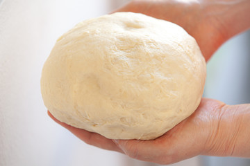 kneading bread dough in female hands