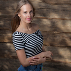 Portrait of beautiful young girl on wooden background.