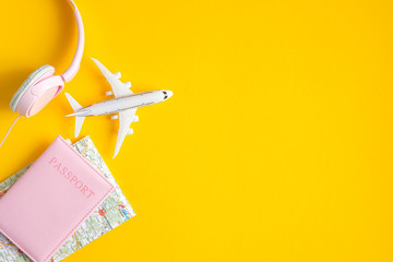 Airplane travel concept. Flat lay traveler accessories on yellow background with copy space. Top...