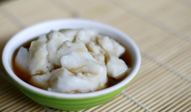 Bubur Sumsum On Bambbo Background. Indonesian Traditional Porridge Made From Rice Flour Served With Brown Sugar Syrup.