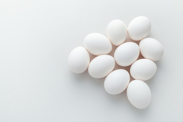 group of white chicken eggs on a gray background