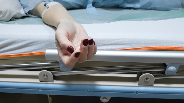 Close-up of female hands with a catheter, which lies on a hospital bed. Coronavirus epidemic. covid-19