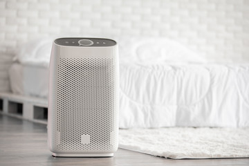 Air purifier in cozy white bed room for filter and cleaning removing dust PM2.5 HEPA in home,for...