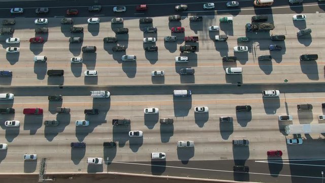 Aerial view from above of cars and trucks traveling in congested road traffic on the I-405 freeway in urban Los Angeles, California.
