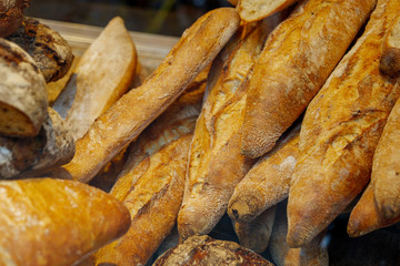 Close up view, heap and stack of French Baguettes at display of bakery store. 