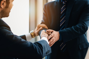 business background of businessman having handshaking after finish business deal