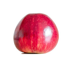 Red apple with a shiny peel. Window reflection