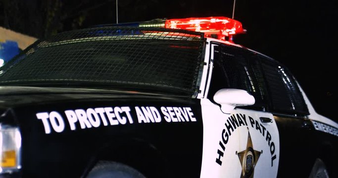 Close up of the police car from the side at night. Police forces vehicle in the dark. Outdoor. To protect and save. Highway patrol concept.