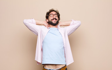 young bearded man expressing a concept against flat wall