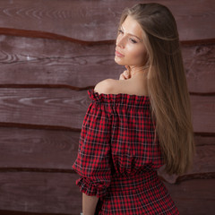 Fototapeta premium Portrait of beautiful young girl on wooden background.