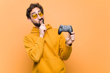 young crazy cool man paying with a game console controller