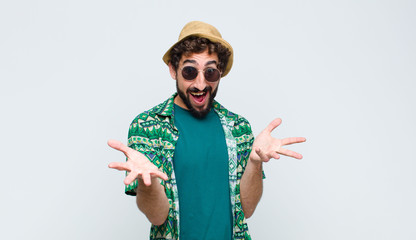 young tourist man feeling happy, astonished, lucky and surprised, like saying omg seriously?...