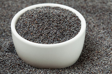 Poppy seeds in bowl. Selective focus.