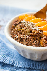 Brown flax seeds healthy dietary breakfast with fruits, sesame, persimmon puree. Losing weight vegan concept.