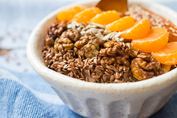 Brown flax seeds healthy dietary breakfast with fruits, sesame, persimmon puree. Losing weight vegan concept.