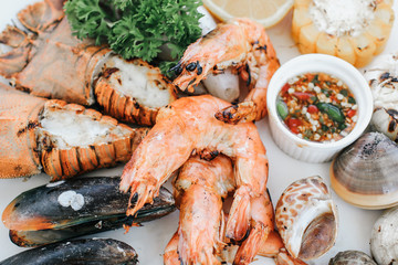 Close up of delicious grilled seafood platter.Tray of mussel, shrimp,prawns and clams with spicy...