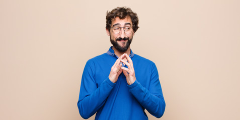 young handsome man scheming and conspiring, thinking devious tricks and cheats, cunning and...