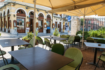 A Greek Athens cafe terrace covered with parasols.