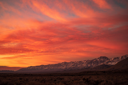 first morning sunlight illuminates snowy mountain peaks in California