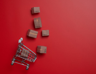 Shopping online, delivery and logistics concept,paper boxes in a small shopping cart