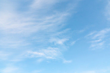 Light cirrus clouds in the blue sky on a sunny day, full frame image, background