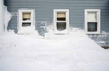 Snow mound under three windows