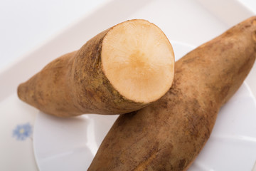 Smallanthus sonchifolius on the white plate, he in the white background, is a nutritional health of...