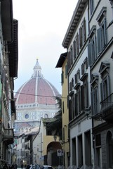 View between buildings of Florence Cathedral, or the Cathedral of Santa Maria del Fiore in Italy 