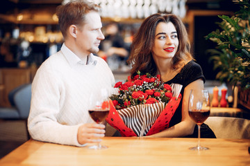 Couple in a restaurant. Lady in a black dress