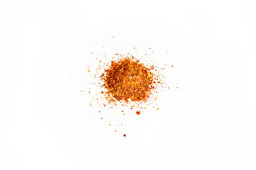 close-up of a pile of organic dry chili flakes isolated on a white background