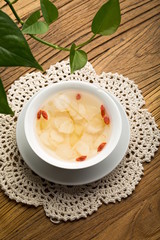 Ginseng has medicinal properties against a white background and can be dipped in water and sliced, also known as American ginseng-Panax quinquefolius