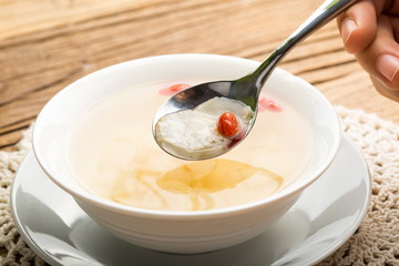 Ginseng has medicinal properties against a white background and can be dipped in water and sliced, also known as American ginseng-Panax quinquefolius