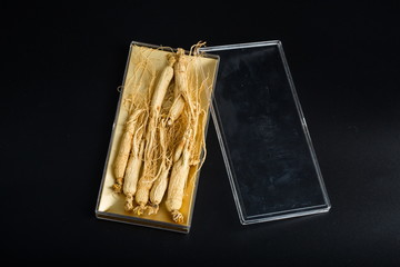 Ginseng has medicinal properties against a white background and can be dipped in water and sliced, also known as American ginseng-Panax quinquefolius